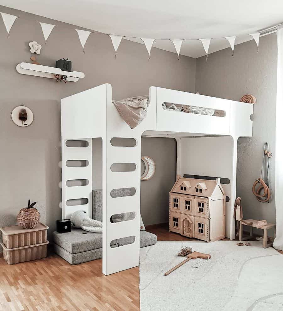 Cozy kids' bedroom with a modern white loft bed, soft reading nook, wooden dollhouse, neutral decor, and playful pennant garland