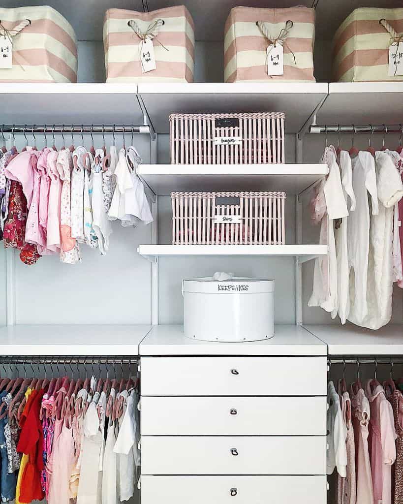 Neatly organized kids' closet with labeled storage bins, hanging clothes, and drawers for easy access to essentials in soft pastel tones