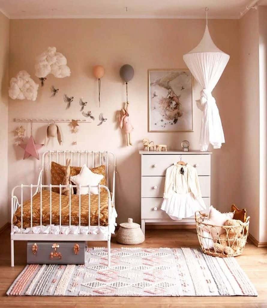 Dreamy girls' bedroom with a vintage-style bed, soft canopy, cloud wall decor, warm neutral tones, and cozy woven storage