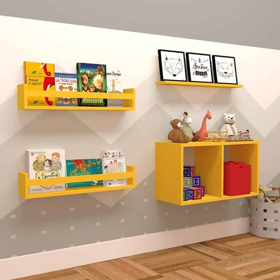 Kids' room wall with yellow floating bookshelves and storage cubes, holding children's books, toys, framed artwork, and decorative items