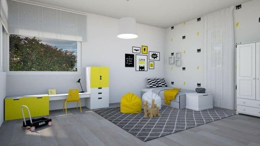 Modern kids' bedroom with a black, white, and yellow superhero theme, featuring a single bed with geometric pillows and a yellow throw blanket, a study desk with storage, a bean bag chair, a patterned area rug, a white wardrobe, and superhero-themed wall decor