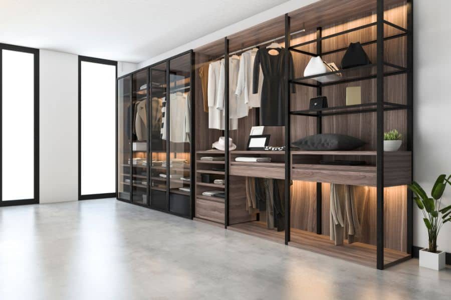 Modern open wardrobe with neatly arranged clothes, shelves, and accessories featuring a minimalist design with wood and glass elements