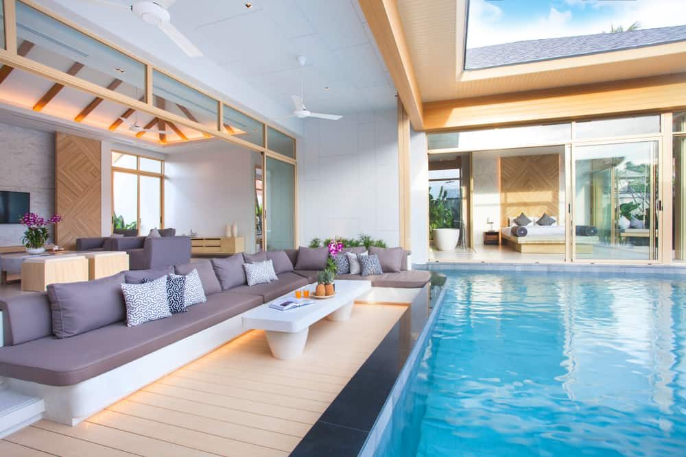 Luxurious modern pool villa with an open-concept design, sleek built-in seating, and a private pool, creating a stylish indoor-outdoor retreat