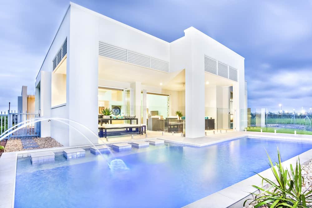 Ultra-modern pool villa with sleek white architecture, open-concept living space, and a stunning pool with elegant water fountains