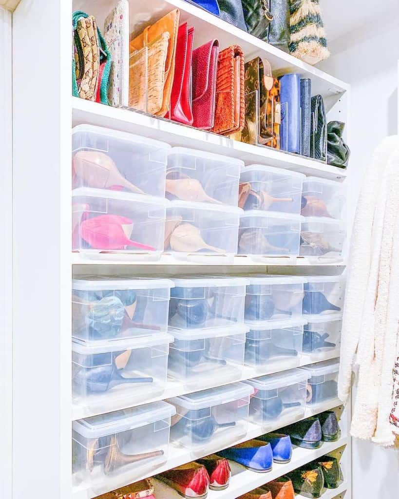 Closet with clear plastic shoe boxes filled with various shoes, colorful handbags are displayed on the top shelf