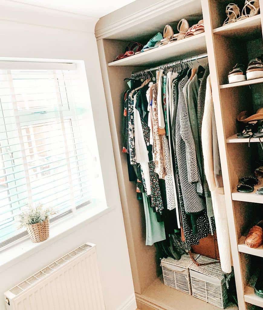 Organized wardrobe with hanging clothes, built-in shelves for shoes, and storage baskets, creating a tidy and stylish closet space