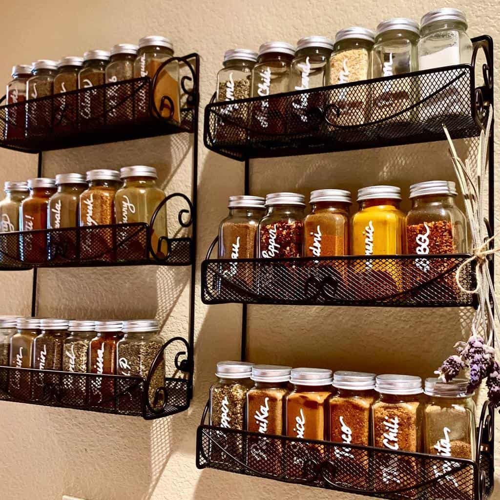 Wall-mounted spice racks with labeled jars of various spices on display