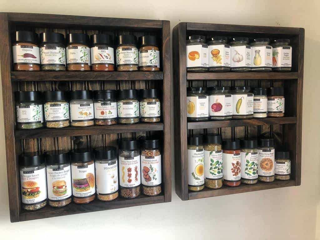 Wooden shelves with neatly organized spice jars, each labeled with different herbs and spices