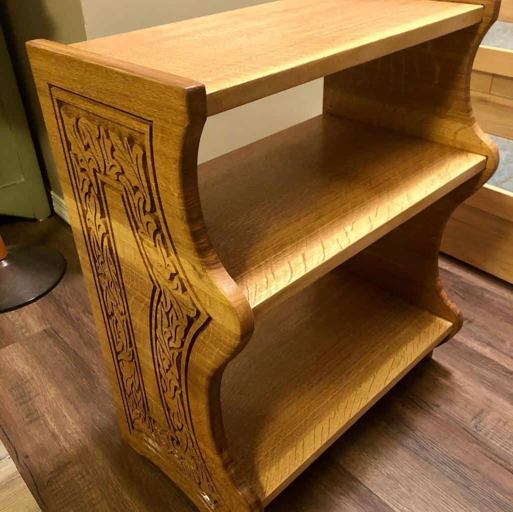 Handcrafted wooden shoe rack with intricate carved side panels, featuring a sturdy three-tier design for stylish storage