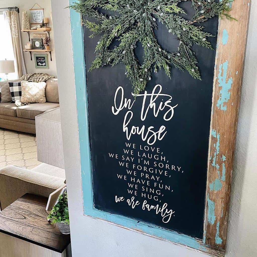 Repurposed old window turned into a rustic chalkboard sign with an uplifting family message, framed with distressed wood.