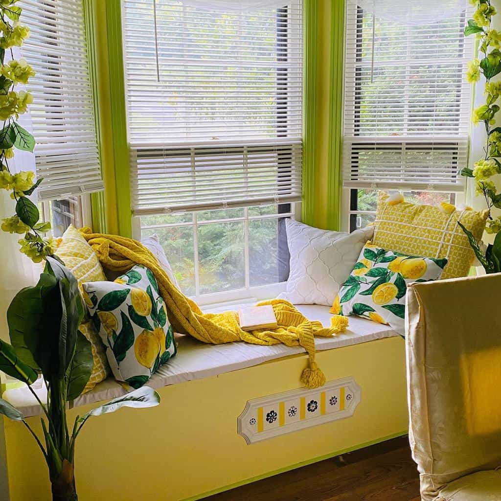 Vibrant bay window nook with lemon-themed pillows, a cozy bench, and bright yellow decor, creating a cheerful and inviting reading spot.