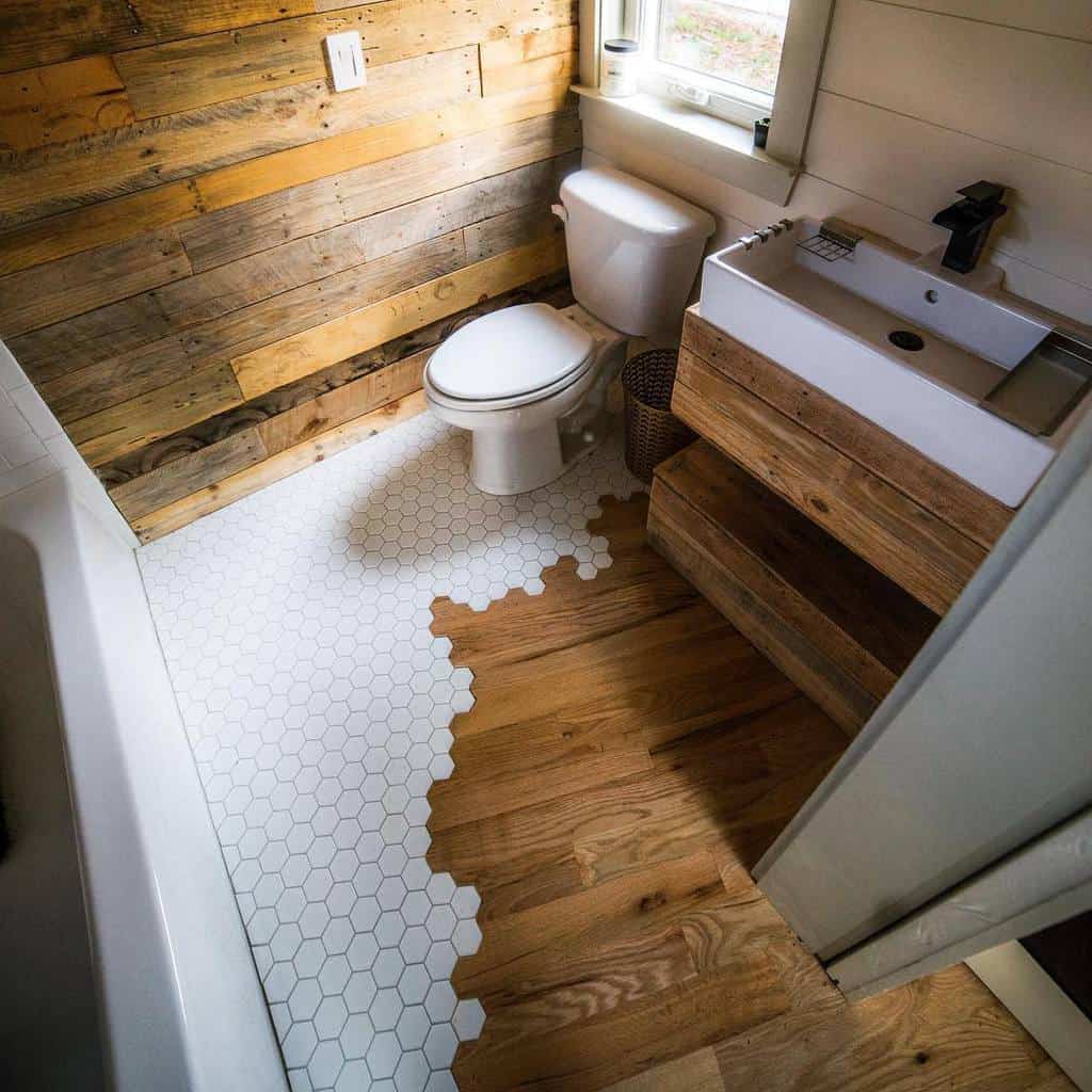 Compact bathroom with wood accents, white hexagonal and wood floor, modern sink, and toilet—ideal for small spaces design ideas.