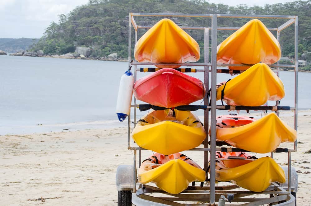 Orange plastic canoe put in a metal rack
