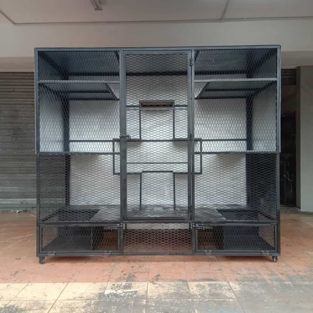 Large black metal catio with mesh walls, multiple shelves, and a secure door, designed for a spacious and safe outdoor cat enclosure