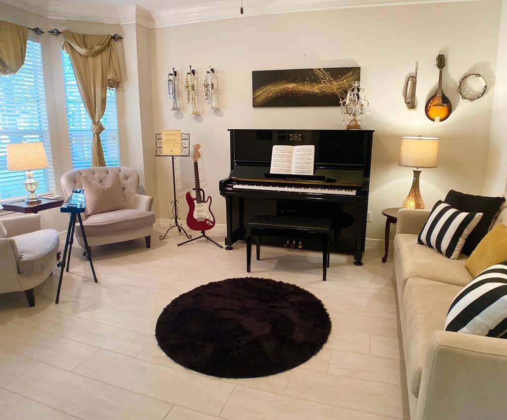 Elegant music room with a black upright piano, guitars, trumpets, cozy seating, gold accents, and a modern black round rug