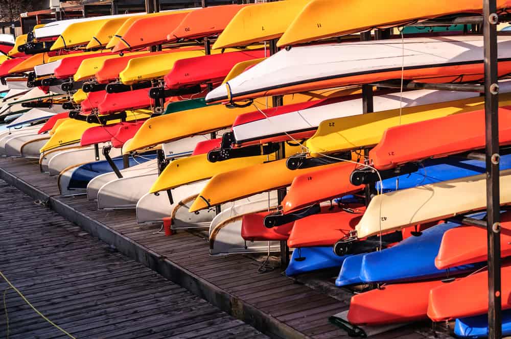 Rack of colorful kayaks on dock