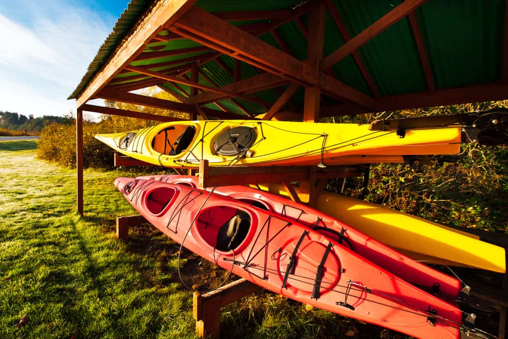 Kayaks under rustic shelter at dawn