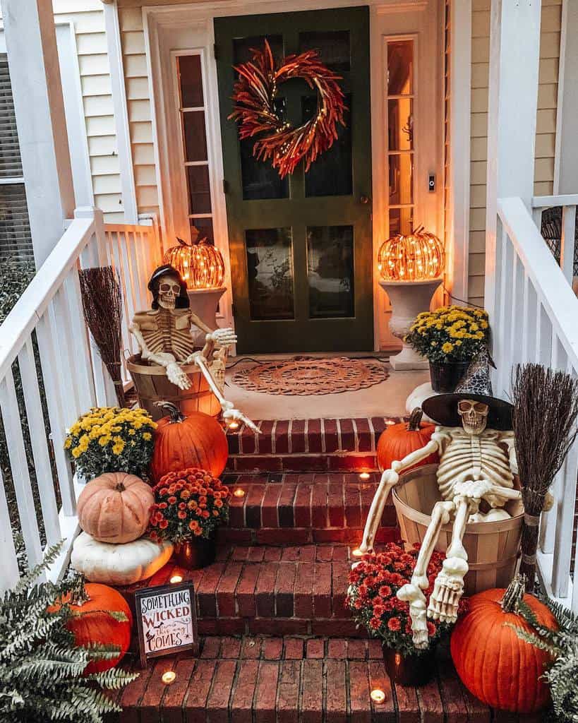 Spooky Halloween porch with glowing pumpkins, skeleton decorations, fall flowers, and eerie lighting, creating a festive and haunting entrance