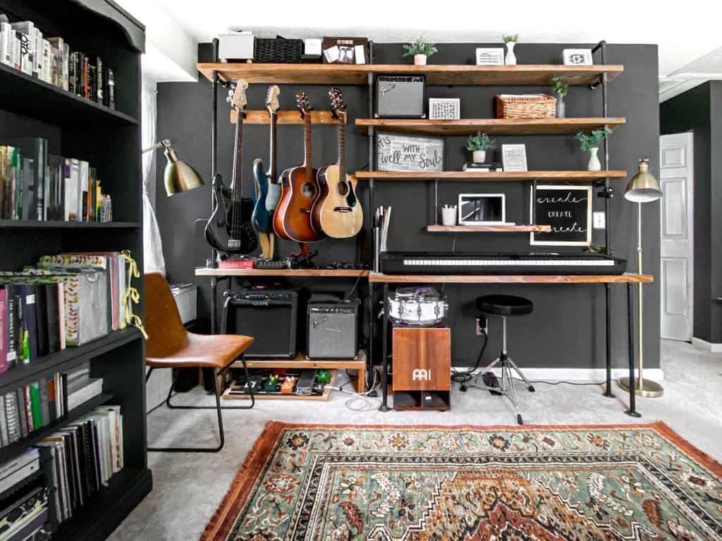 Modern music room with wall-mounted guitars, a keyboard, amplifiers, open shelving, a vintage rug, and a cozy reading nook