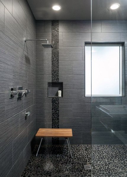 doorless walk-in shower with pebbled tile flooring