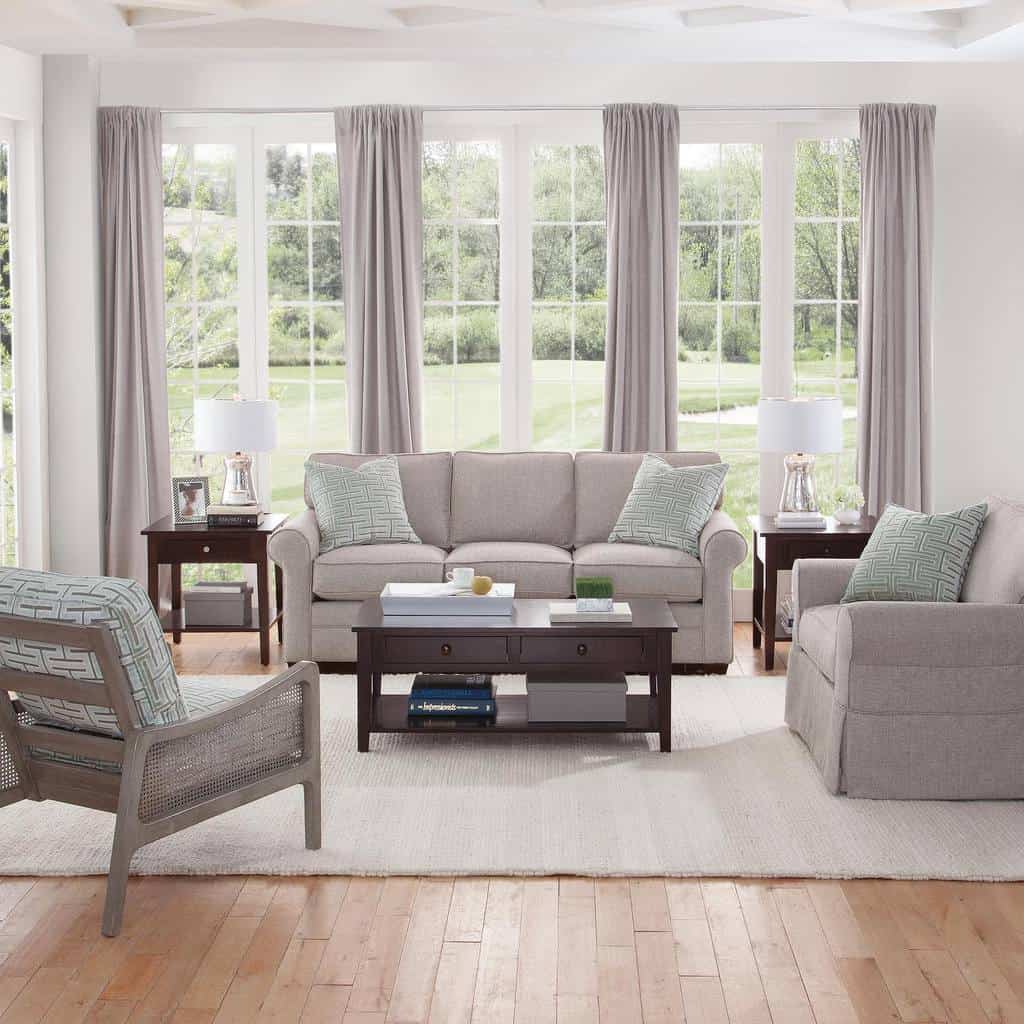 Classic wooden coffee table with storage drawers and a lower shelf, styled with books and decor, set in a bright living room with neutral tones