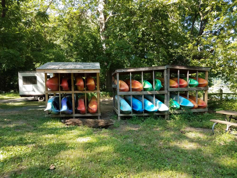 Wooden racks with colorful kayaks