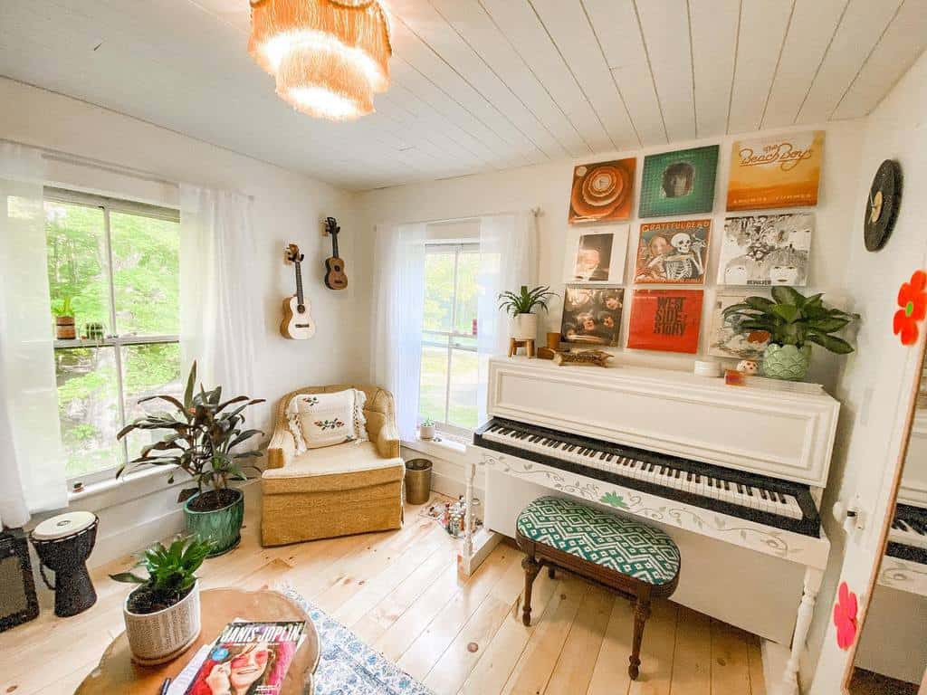 Bright and cozy retro music room with a white upright piano, vinyl records, ukuleles, vintage decor, indoor plants, and natural light