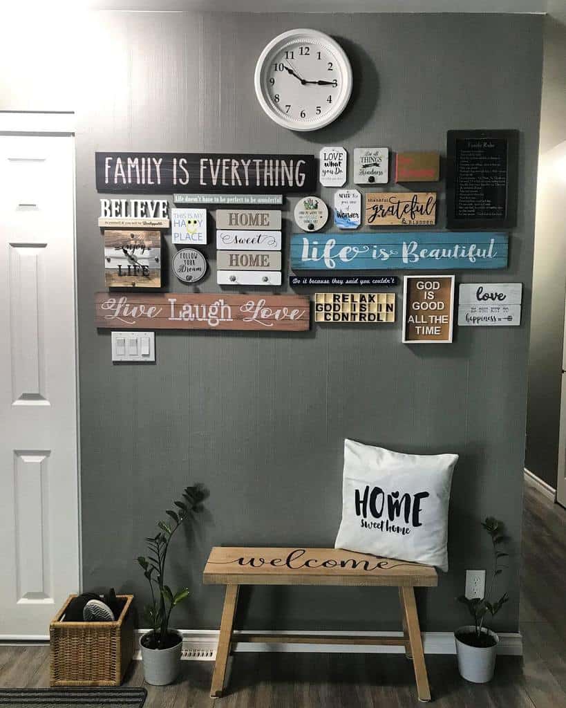 Warm and welcoming entryway with a wooden bench, inspirational wall signs, a cozy pillow, and greenery for a rustic charm