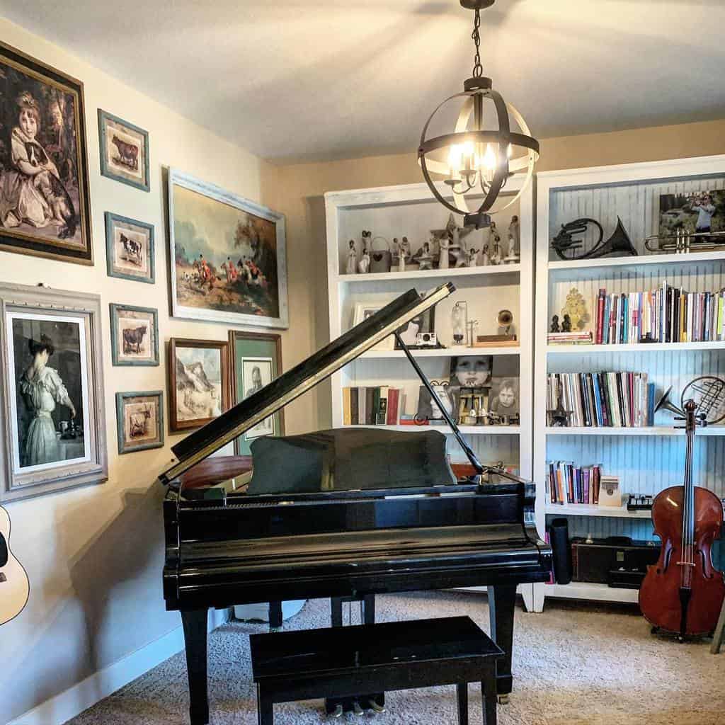 Vintage-inspired music room with a grand piano, framed artwork, built-in bookshelves, a cello, and warm decorative accents