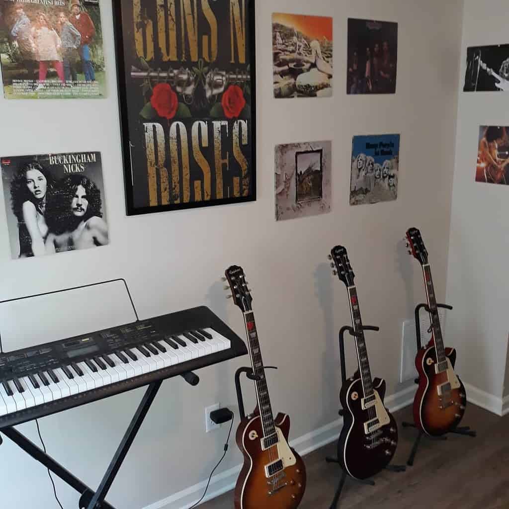 Rock-inspired music room with a keyboard, electric guitars, framed Guns N' Roses poster, and classic album covers on the wall