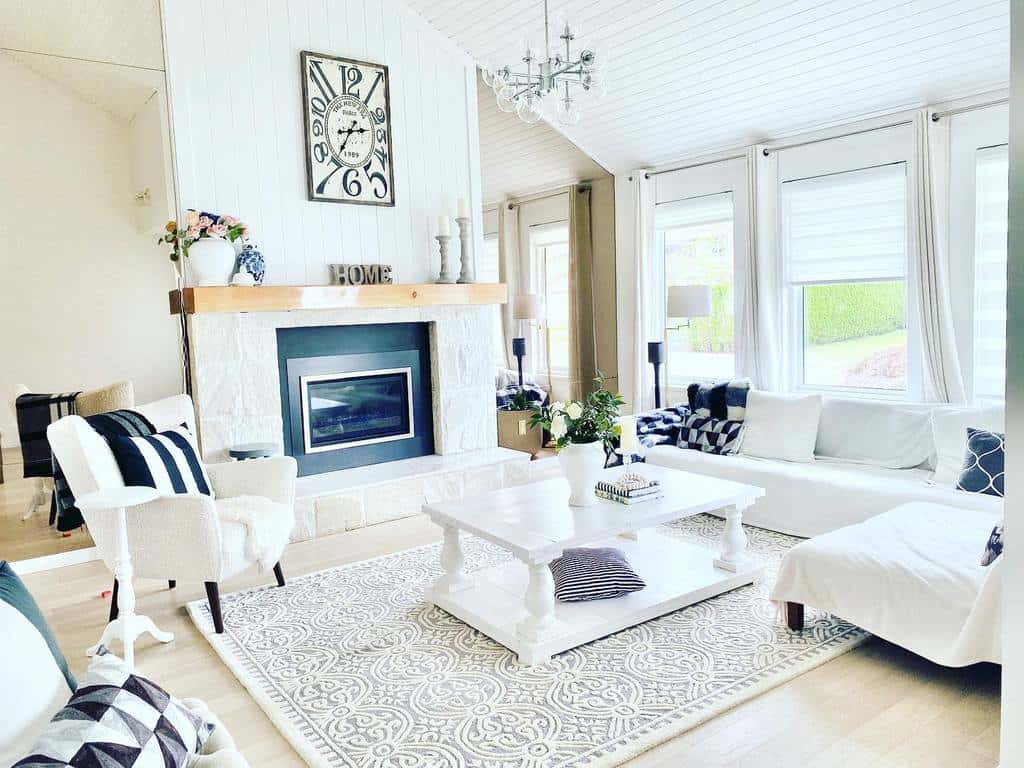 Elegant white wooden coffee table with turned legs and a lower shelf, styled with books and a potted plant, set in a bright living room with a fireplace