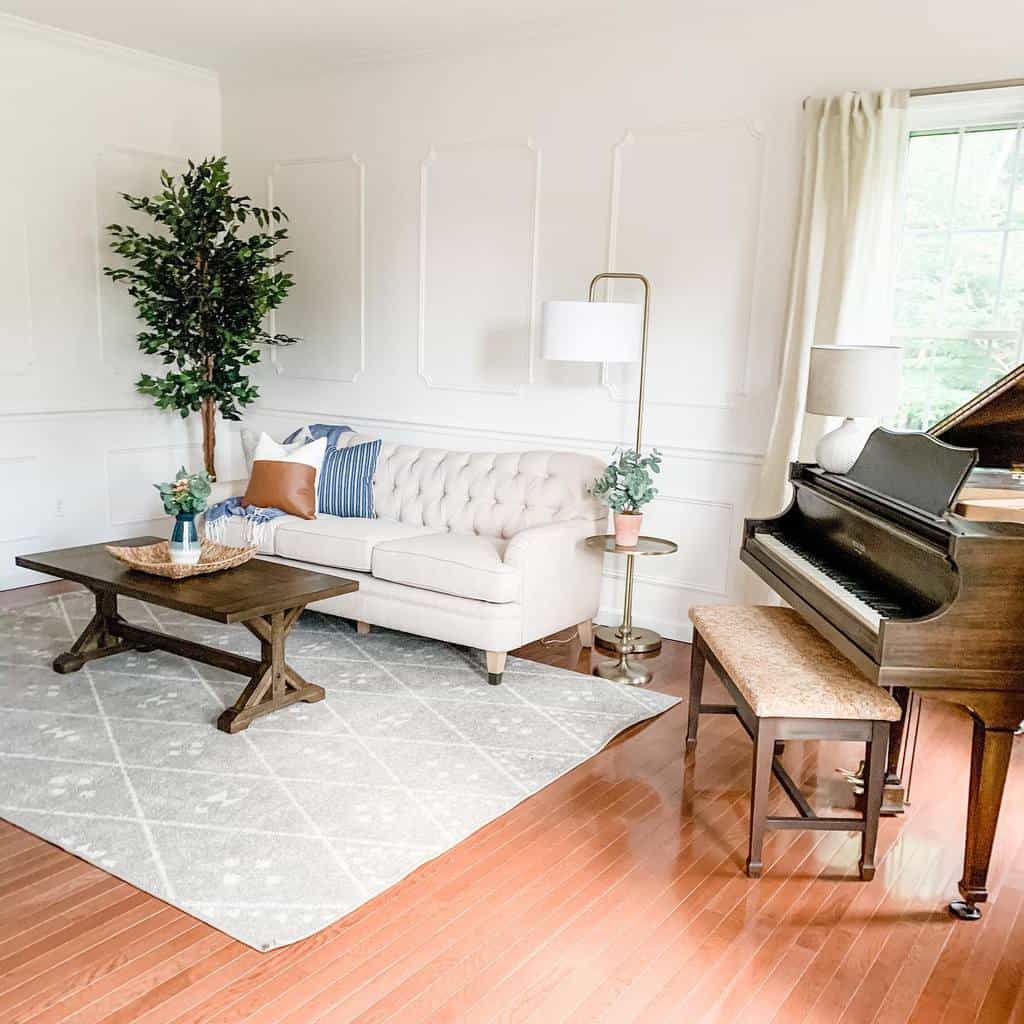 A cozy living room with a white tufted sofa, wooden table, gray rug, grand piano, floor lamp, and a tall indoor plant