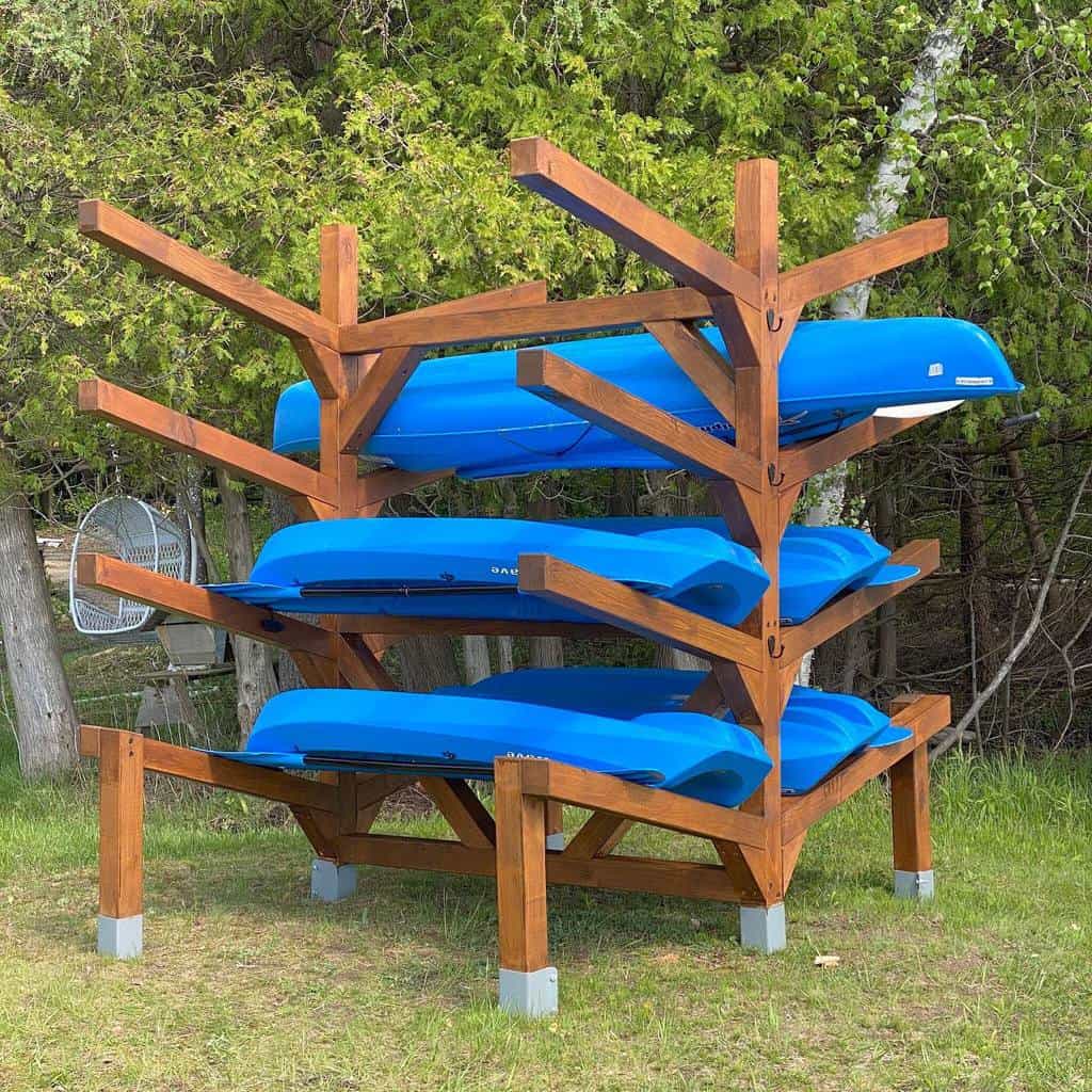 Blue kayaks on wooden storage rack