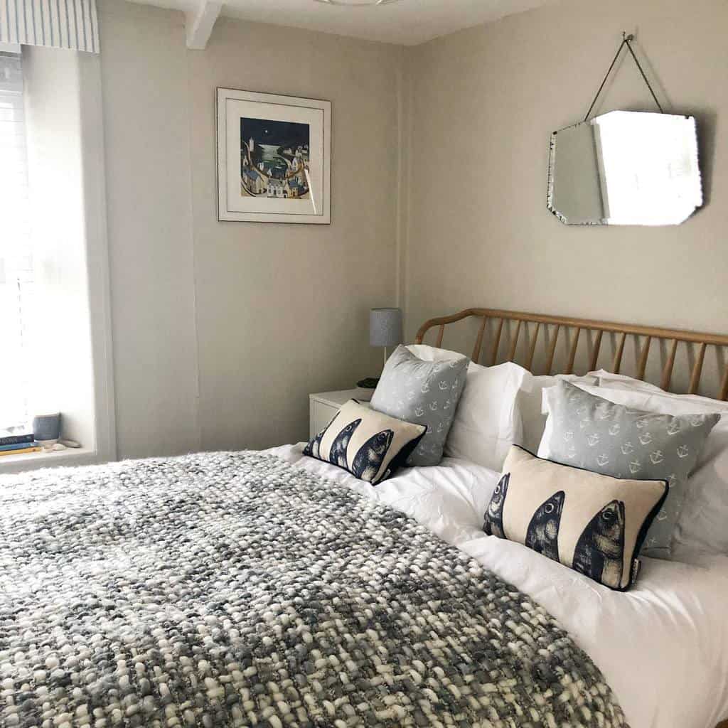 Cozy coastal bedroom with a rattan headboard, nautical-themed pillows, and soft textures in neutral tones for a relaxed seaside retreat