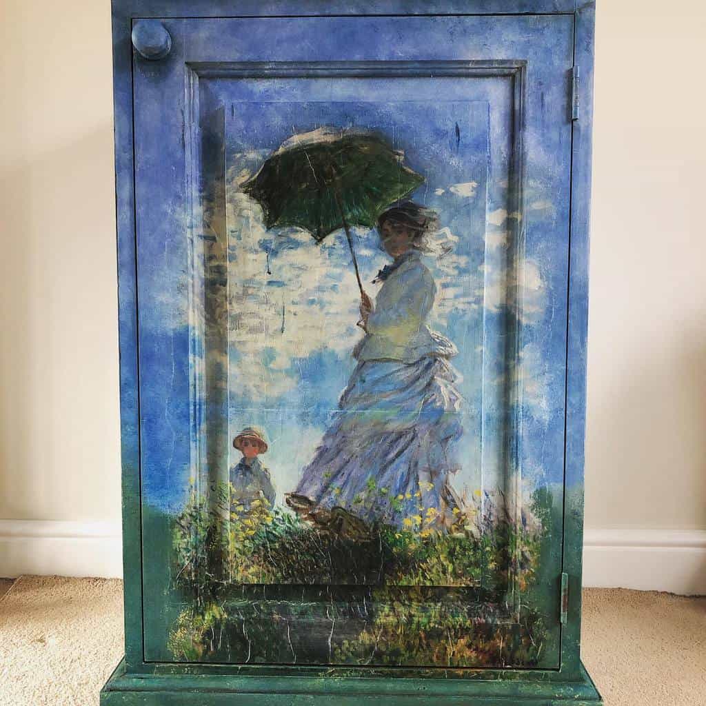 Hand-painted cabinet featuring Monet's 'Woman with a Parasol' design, blending blue and green chalk paint for an artistic vintage look