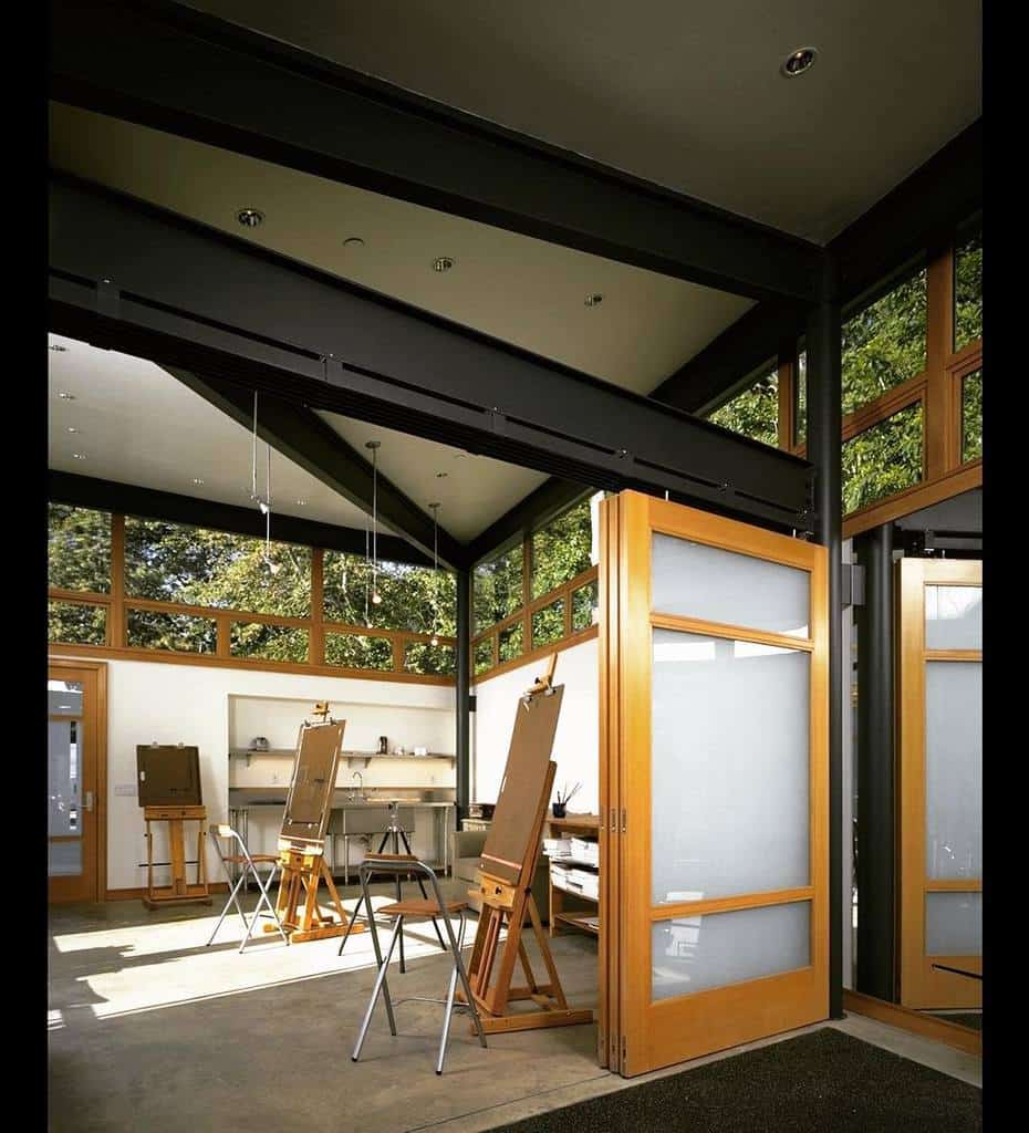 Art studio with easels, open sliding doors, large windows, and natural light streaming in from outside