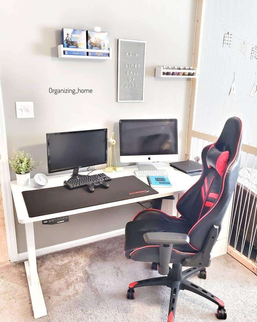 A gaming setup with two monitors, keyboard, gaming chair, and wall decor; shelves hold games and accessories; plants decorate the desk