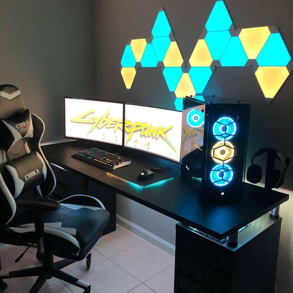 Sleek gaming setup with dual monitors, illuminated PC, LED wall lights, and gaming chair in a modern room