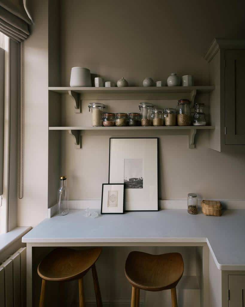 Muted-tone open shelves display ceramic decor and glass jars with pantry staples, creating a minimalist, cozy feel in this modern kitchen nook