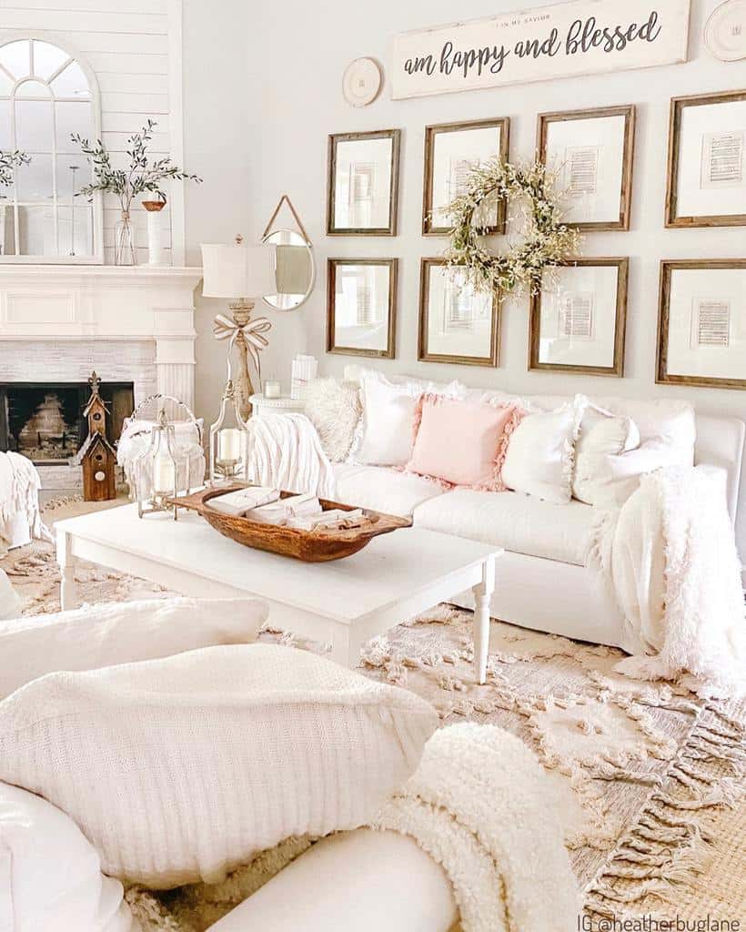 Bright farmhouse living room with a cozy white sofa, soft pastel accents, and a wood sign reading 'I am happy and blessed' above framed decor