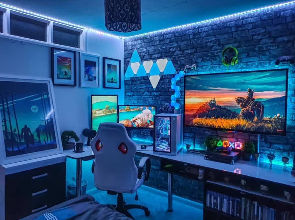 Gaming setup in a room with neon lights, multiple monitors displaying games, a white chair, and various gaming accessories