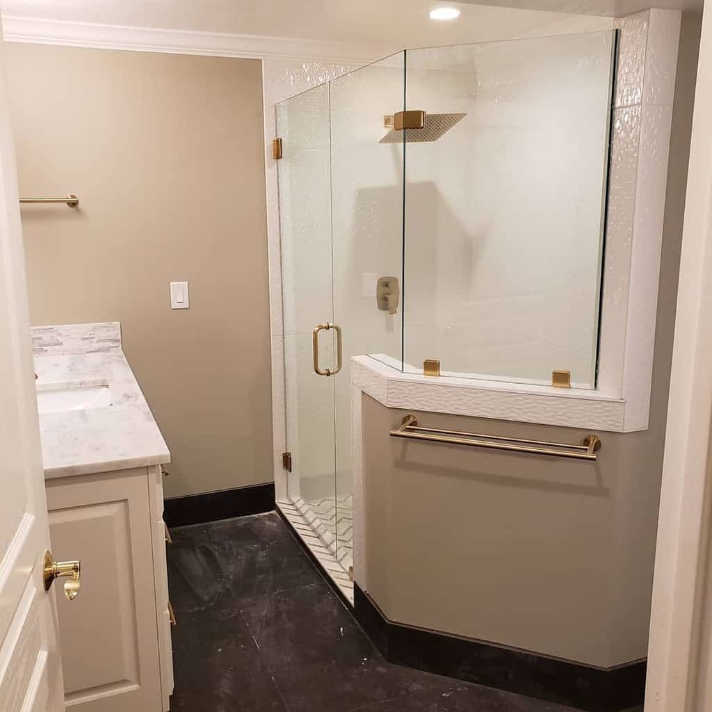 wet bathroom with marble countertop