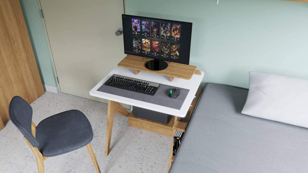 Small room with a desk setup featuring a monitor displaying a game, keyboard, and mouse; chair and bed nearby; minimalist decor