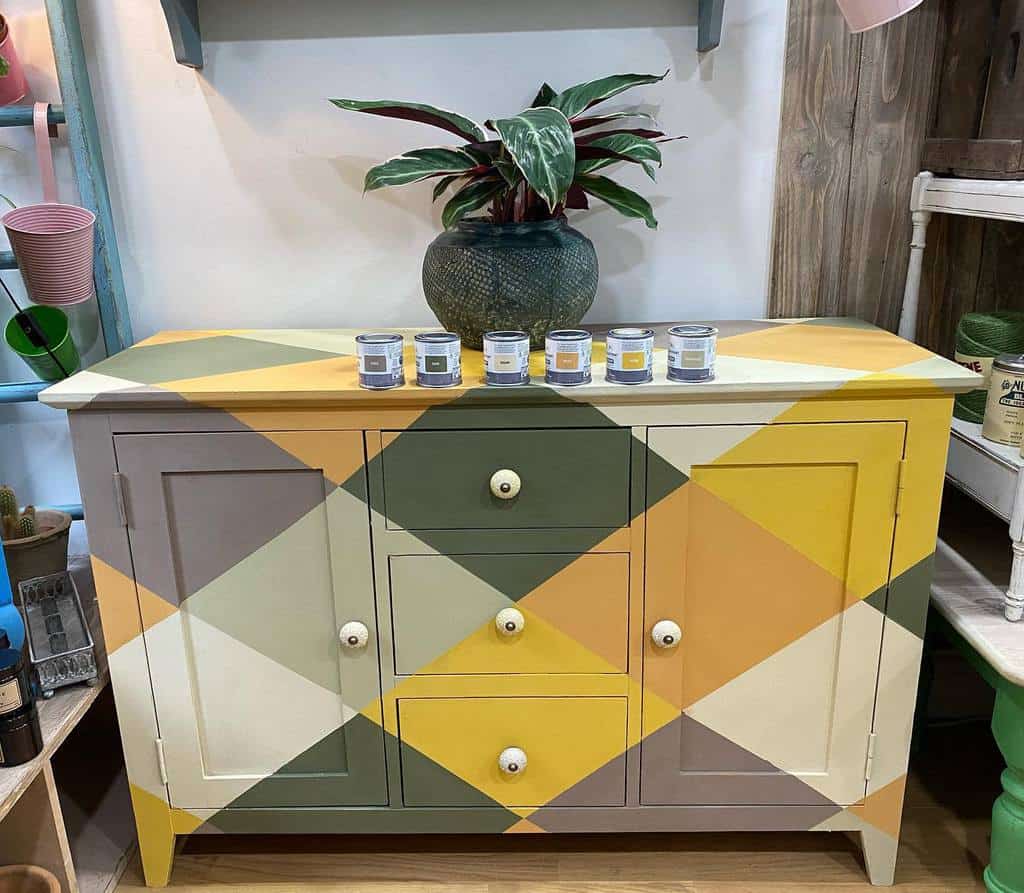 Bold geometric chalk-painted sideboard with a mustard, olive, and neutral color palette, creating a striking modern statement piece