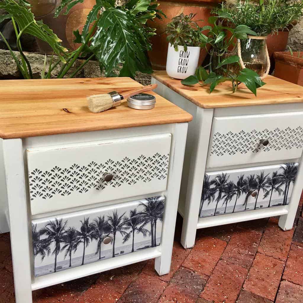 Coastal-inspired nightstands with white chalk paint, intricate stencil detailing, black-and-white palm tree prints, and natural wood tops