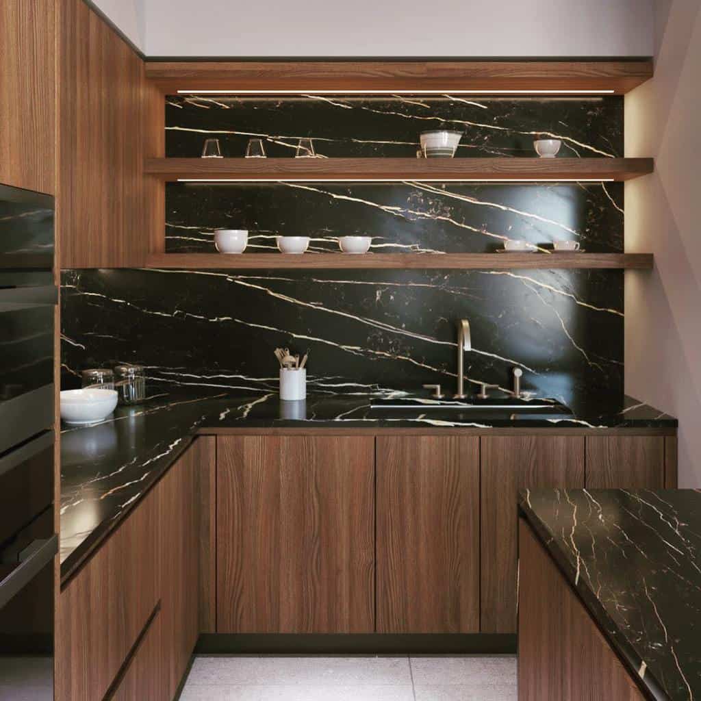 Modern kitchen with wood cabinets, black marble countertops, and open shelves displaying cups and glasses; stainless steel faucet