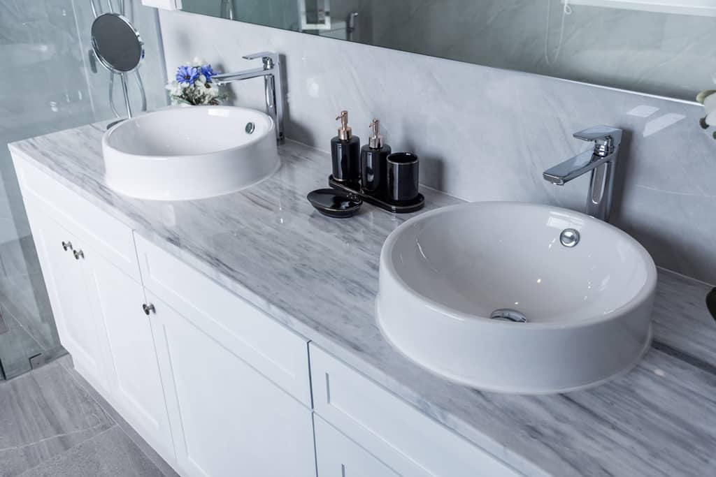 banthroom with sink in a white paint and marble countertop