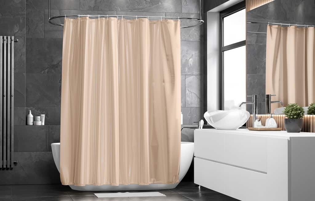 bathroom with bath tub and beige closed shower curtain