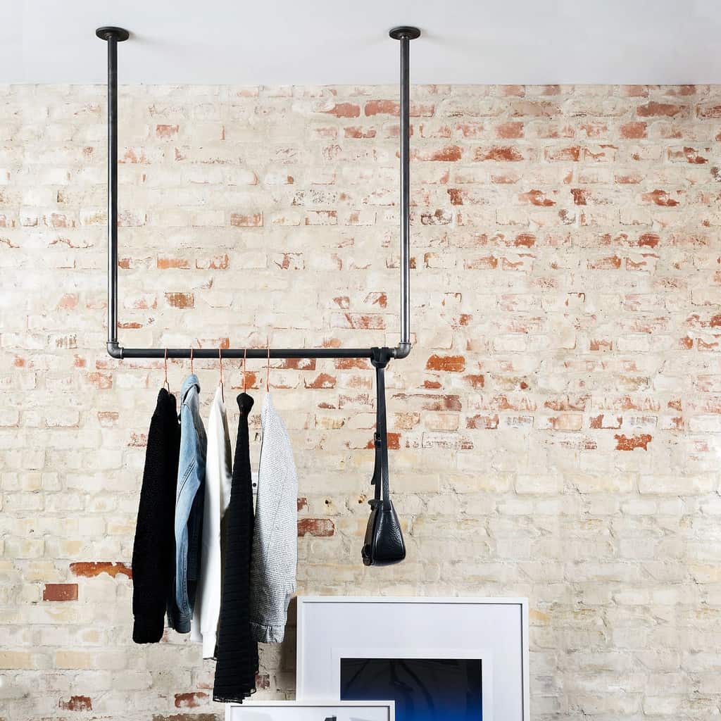 store clothes in a ceiling suspended rack without a closet