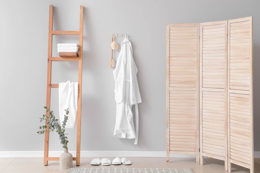 store clothes in a decorative ladder without a closet